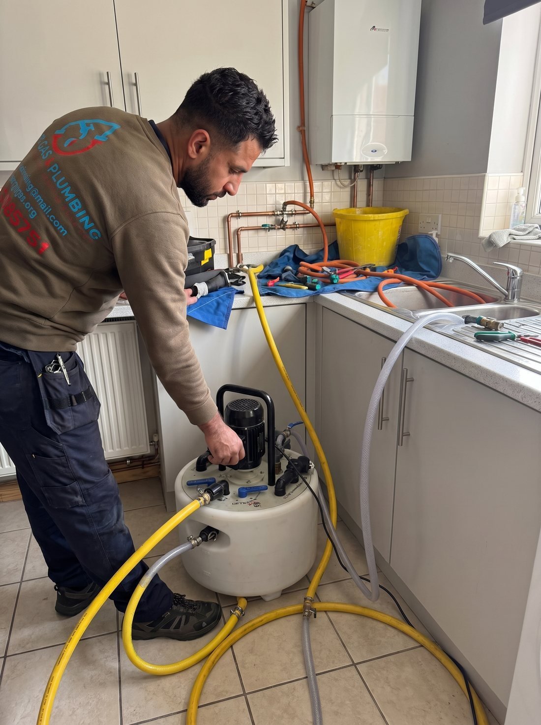 Synergy Gas & Plumbing engineer carrying out a power flush